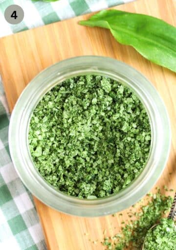 jar with homemade wild garlic salt on a cutting board.