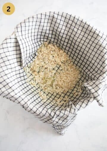straining elderflowers through a cloth to make jelly.
