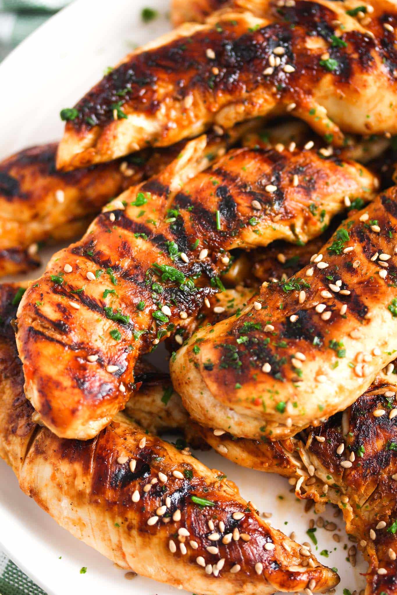 close up of chicken strips with grill marks on them.