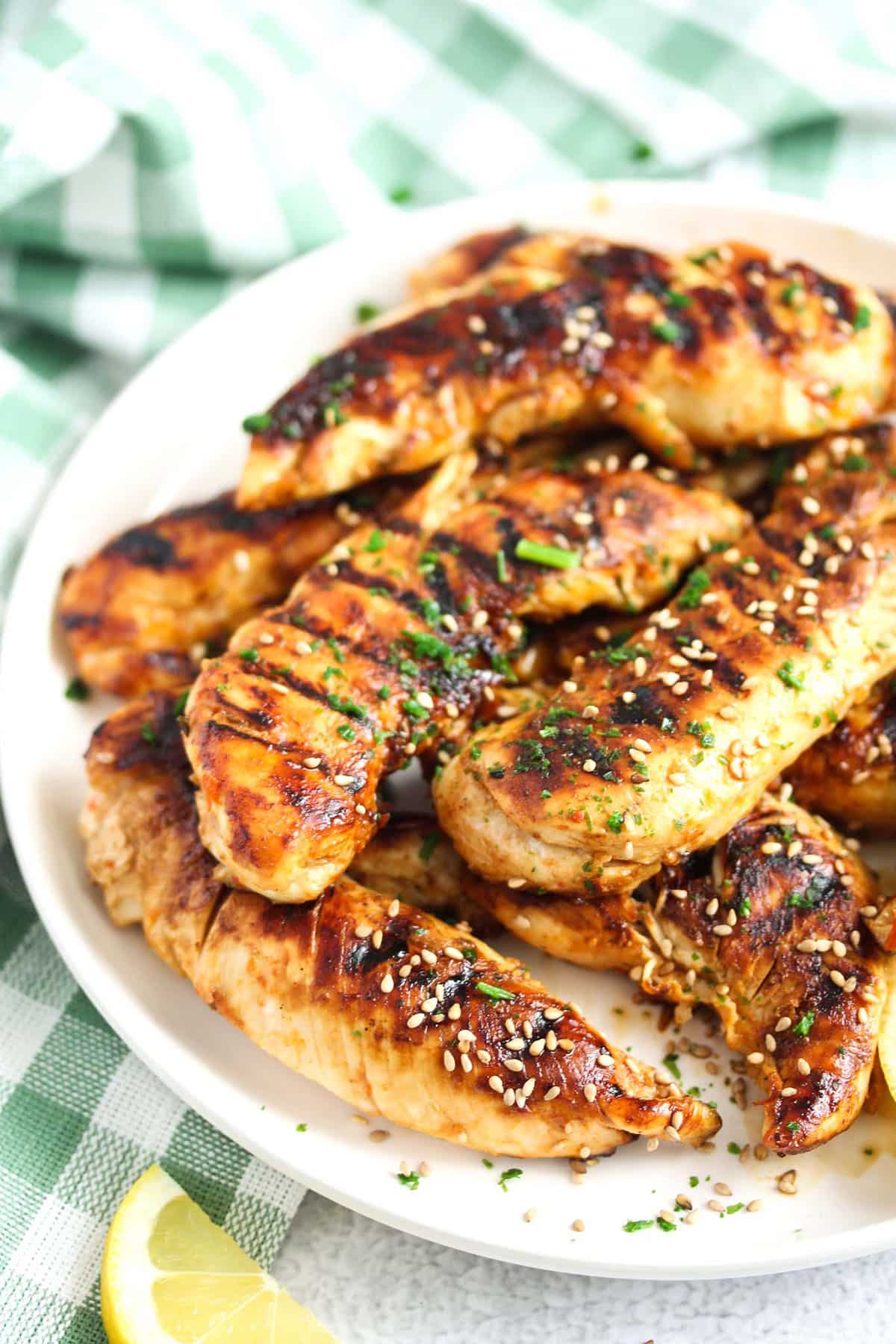many marinated chicken tenders stapled on a plate.