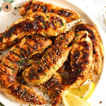 marinated and grilled chicken tenderloins on a plate.