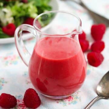 raspberry salad dressing in a small pouring container.