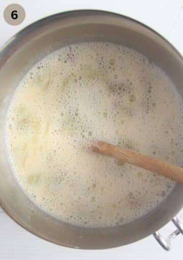 stirring cooked rhubarb into egg mixture with a wooden spoon to make custard.