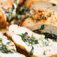 sliced chicken breast showing the creamy spinach filling.