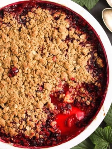 black currant crumble with apples in a baking dish.