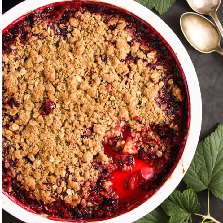 black currant crumble with apples in a baking dish.