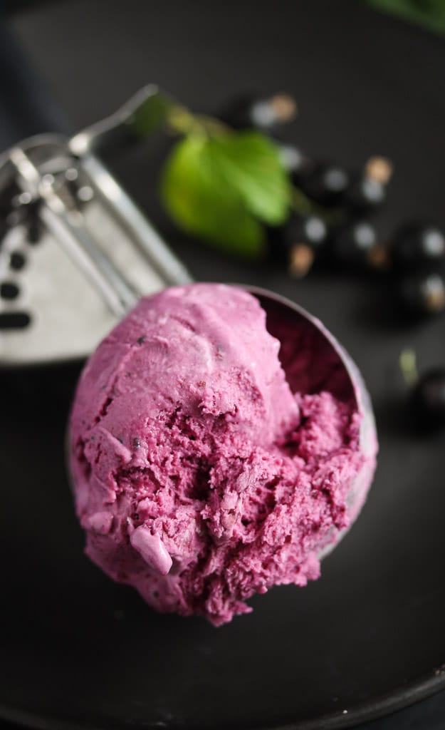 close up of a ball of purple ice cream in a scoop.