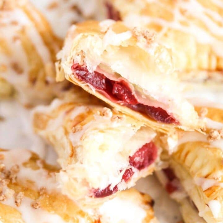 easy cherry turnovers close up, one split in two showing the filling.