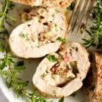 pinterest image of stuffed medallions on a platter with herbs.