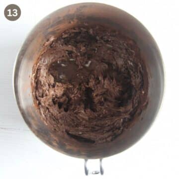making chocolate buttercream in a metal bowl.