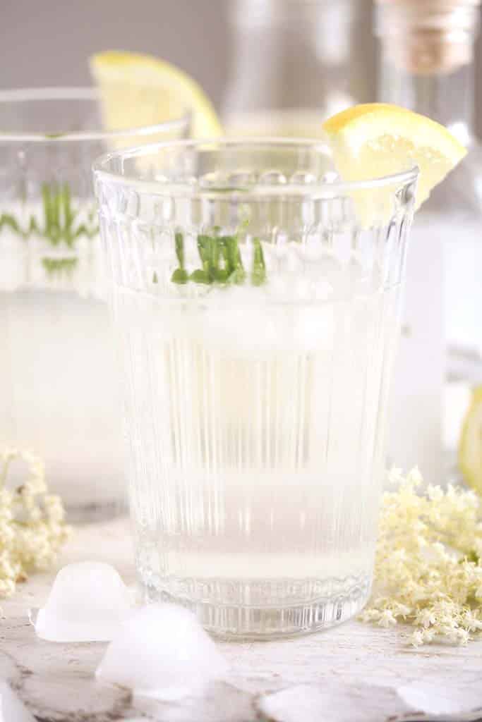 serving gin with elderflower syrup in a long glass.