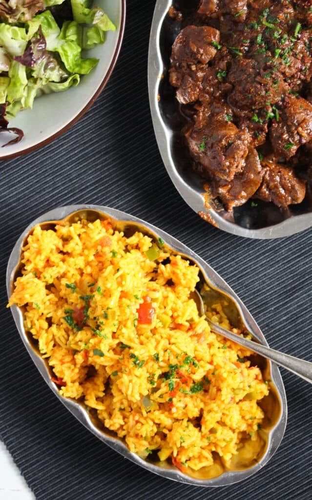 three platter with nando's spicy rice, chicken livers and salad.