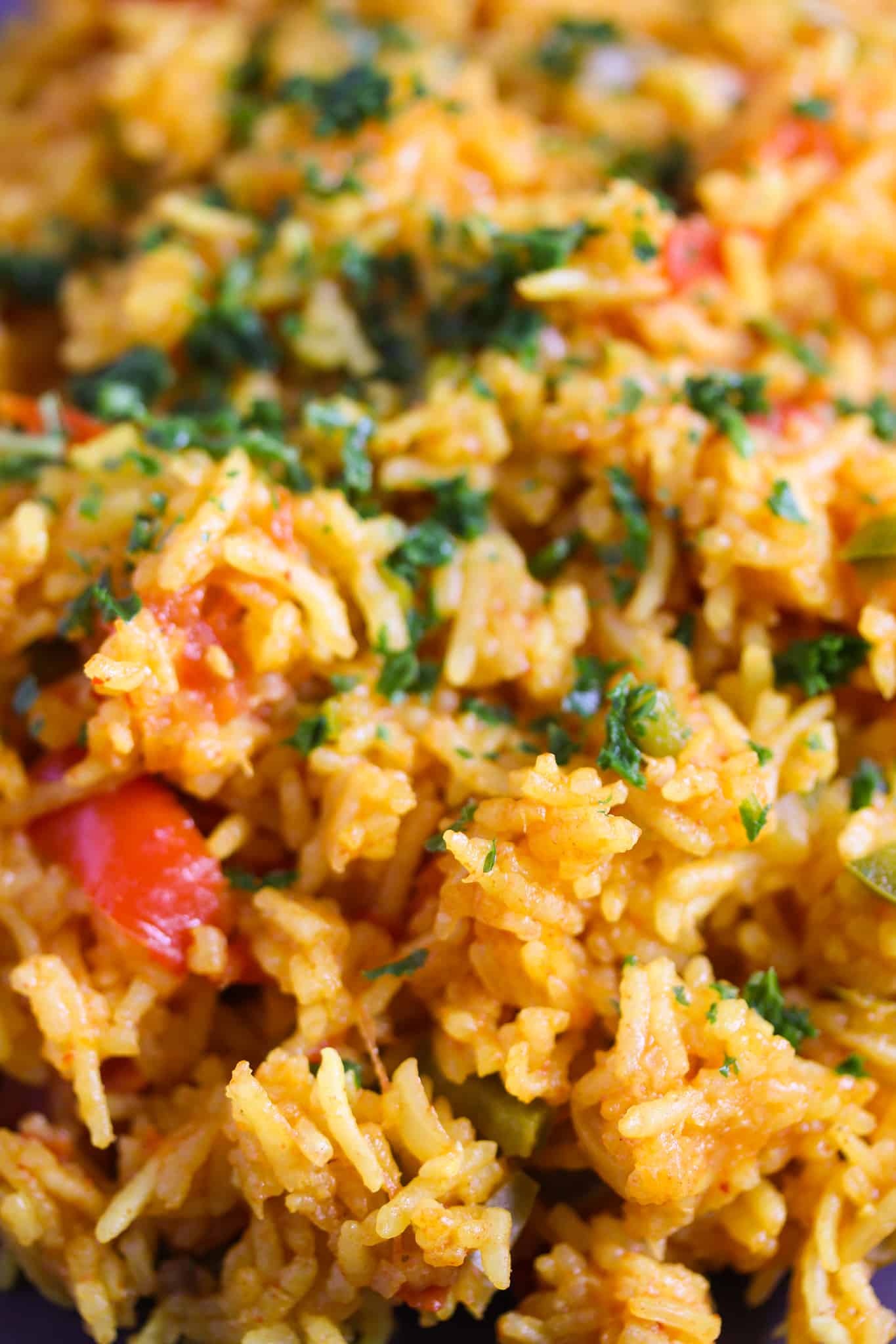 rice with tomatoes and turmeric close up on a plate.