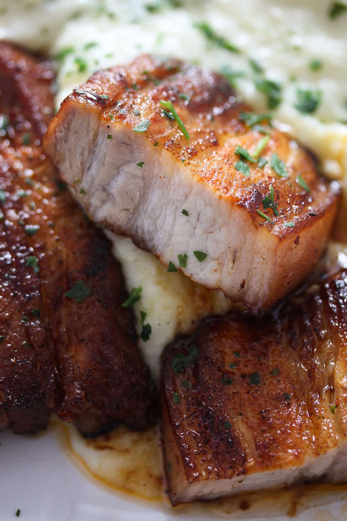 thick pieces of pork belly served with mashed potatoes.