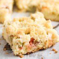 rhubarb crumb cake piece being lifted from the tray.