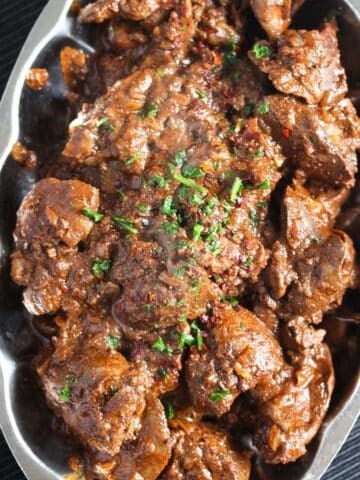 spicy peri peri chicken livers on a small vintage platter.