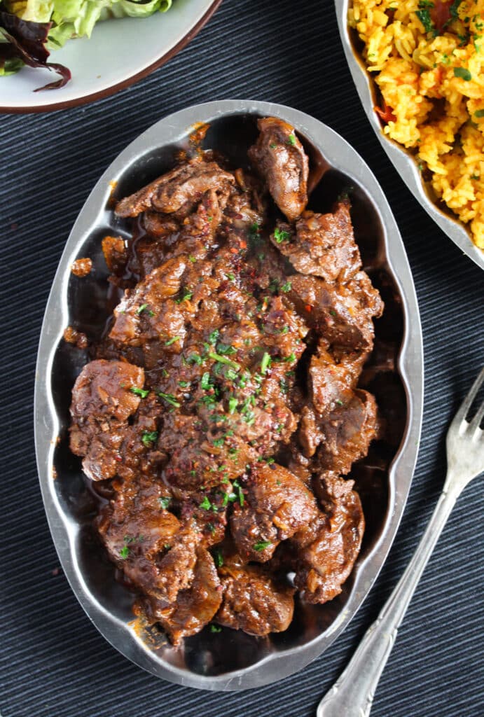chicken livers with spices on a small platter.