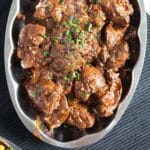 pinterest image of livers cooked in spicy sauce.
