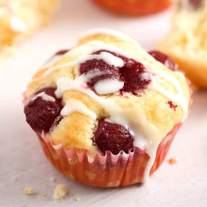one quark muffin topped with cherries and icing.