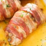 pinterest image of thighs wrapped in bacon sprinkled with parsley.