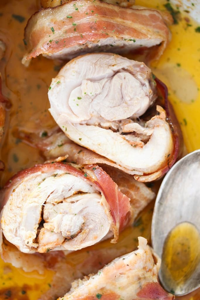 several slices of chicken wrapped in bacon overhead view.