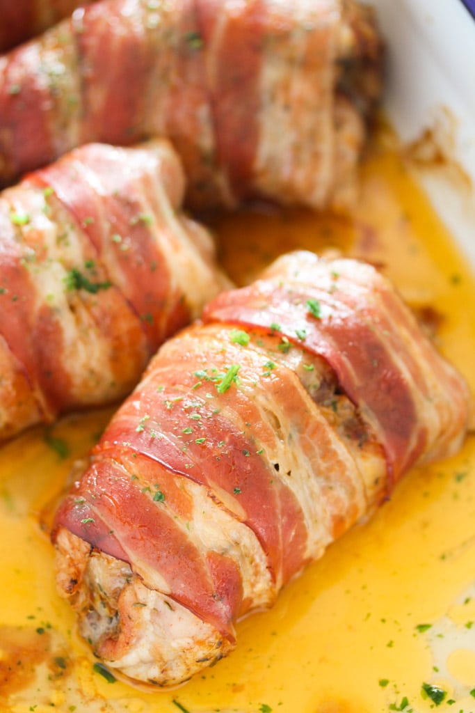 close up rolled up meat with bacon and sprinkled with parsley.