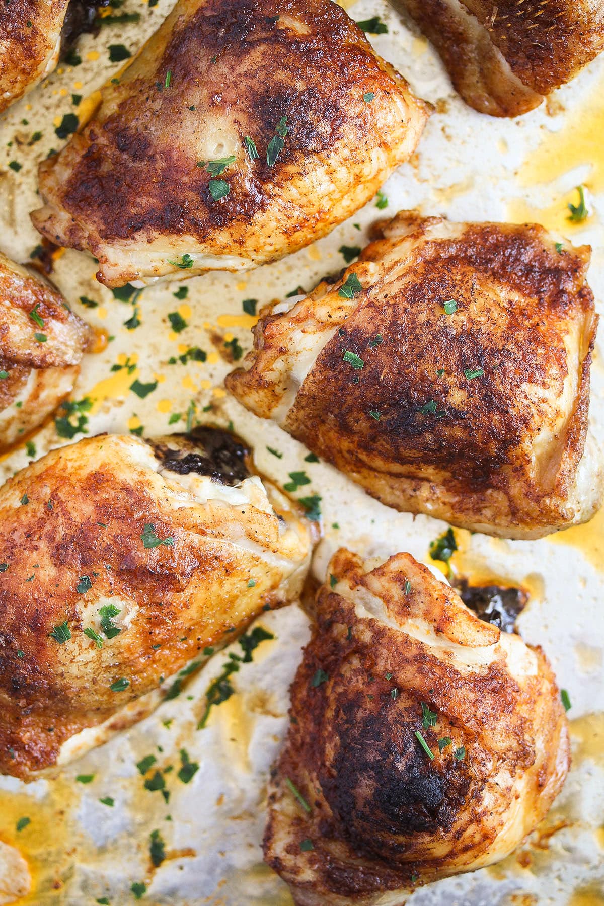 chicken thighs baked from frozen on a baking sheet.
