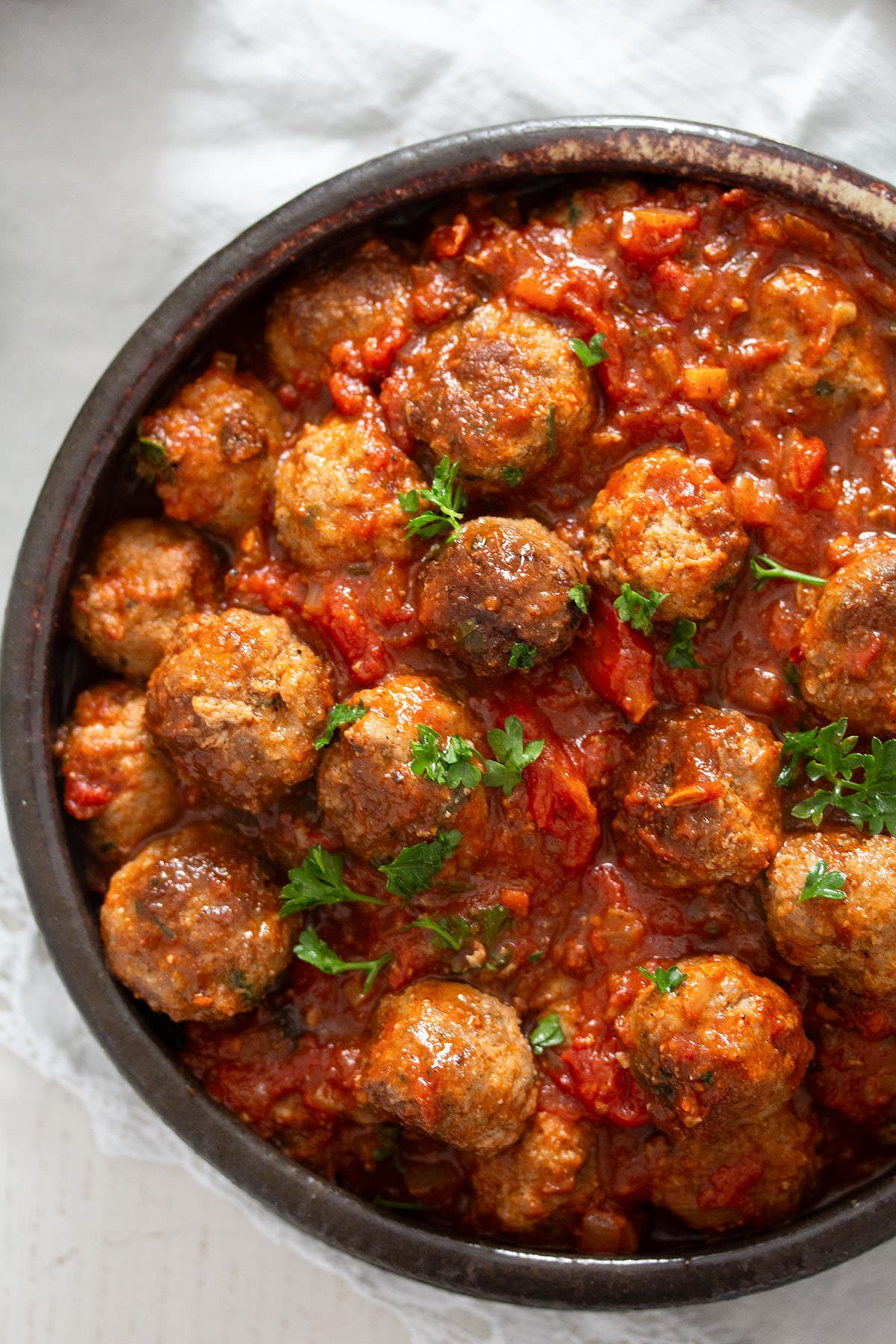 spanish meatball tapas served in tomato sauce in a small bowl.