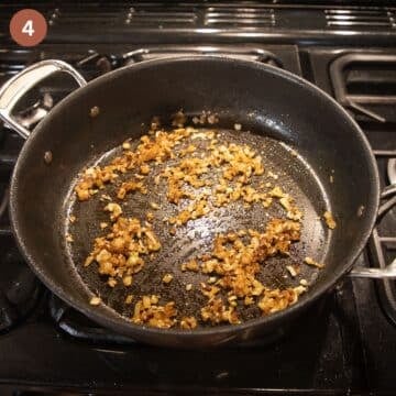 sauteing onions and garlic for making spanish meatball sauce in a large pan.