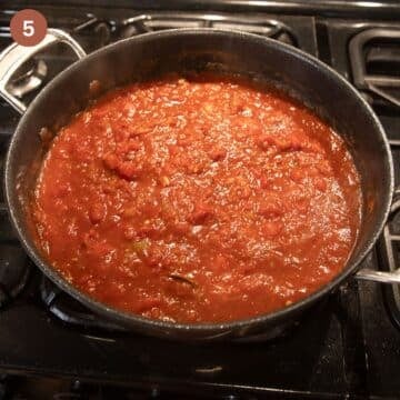 simmering tomato sauce for albondigas in a large saucepan.
