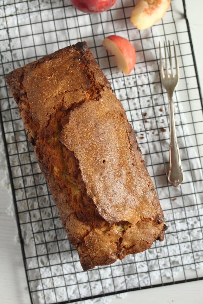 overhead image of peach pound cake with sugar coating on a rack.