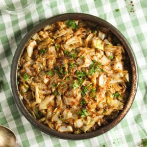 cooked sweetheart cabbage in a bowl on a striped kitchen cloth.