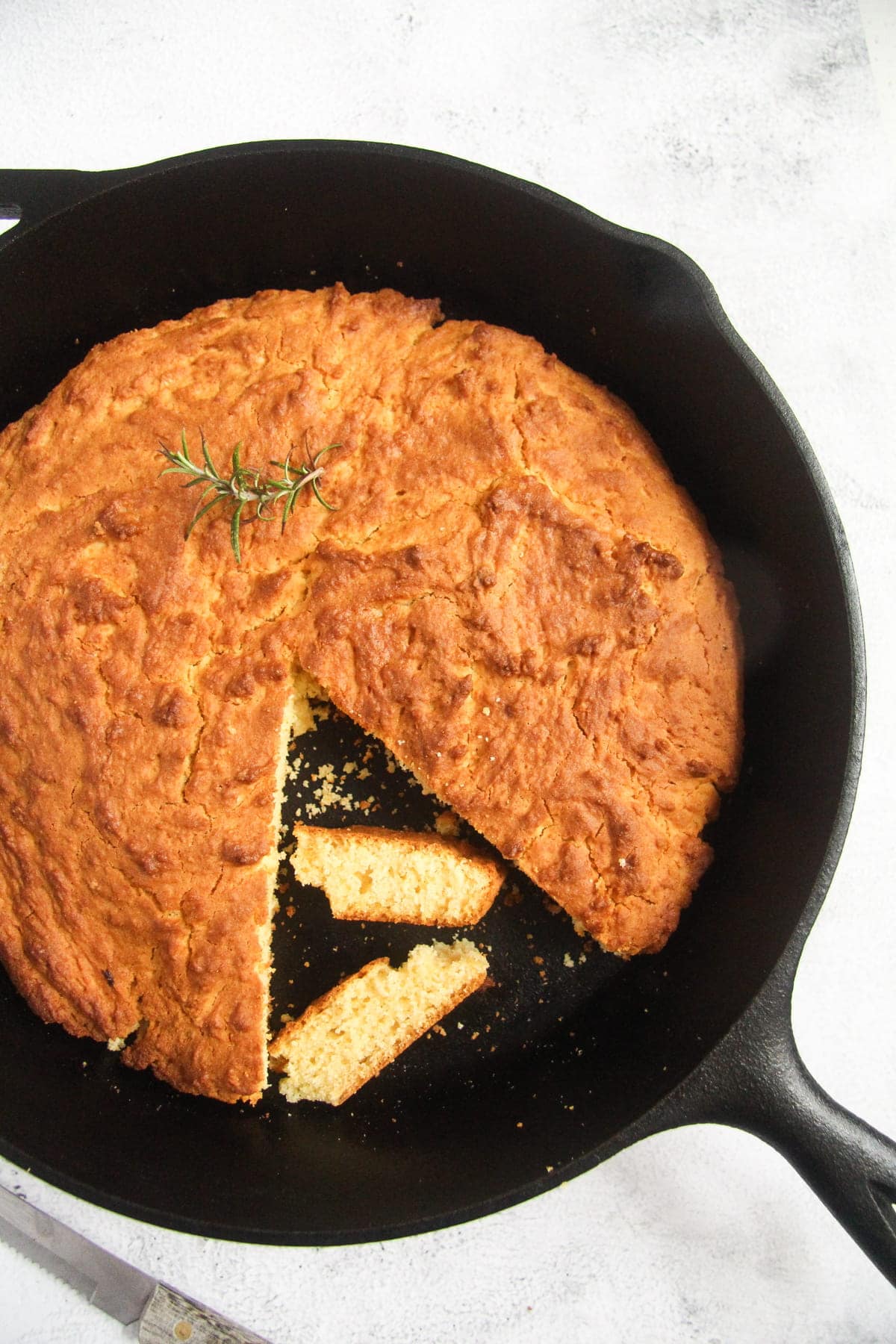 cast iron pan with golden brown cornbread in it.