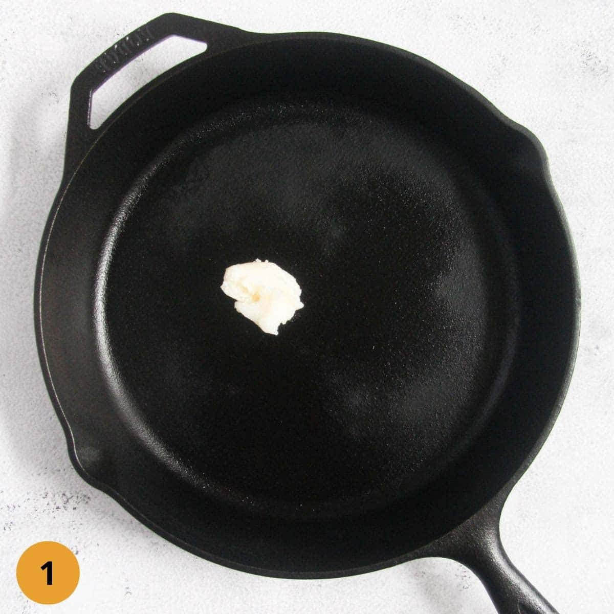 black cast iron skillet with some fat in it.