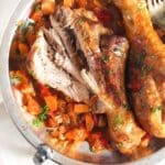 pinterest image of two turkey legs with vegetables.