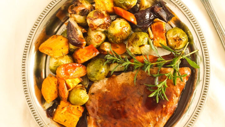 overhead view of a plate with turkey breast and roasted vegetables.