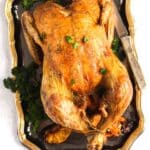 pinterest image of roasted chicken on a silver platter.