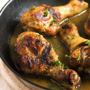 close up of three stove top chicken legs.