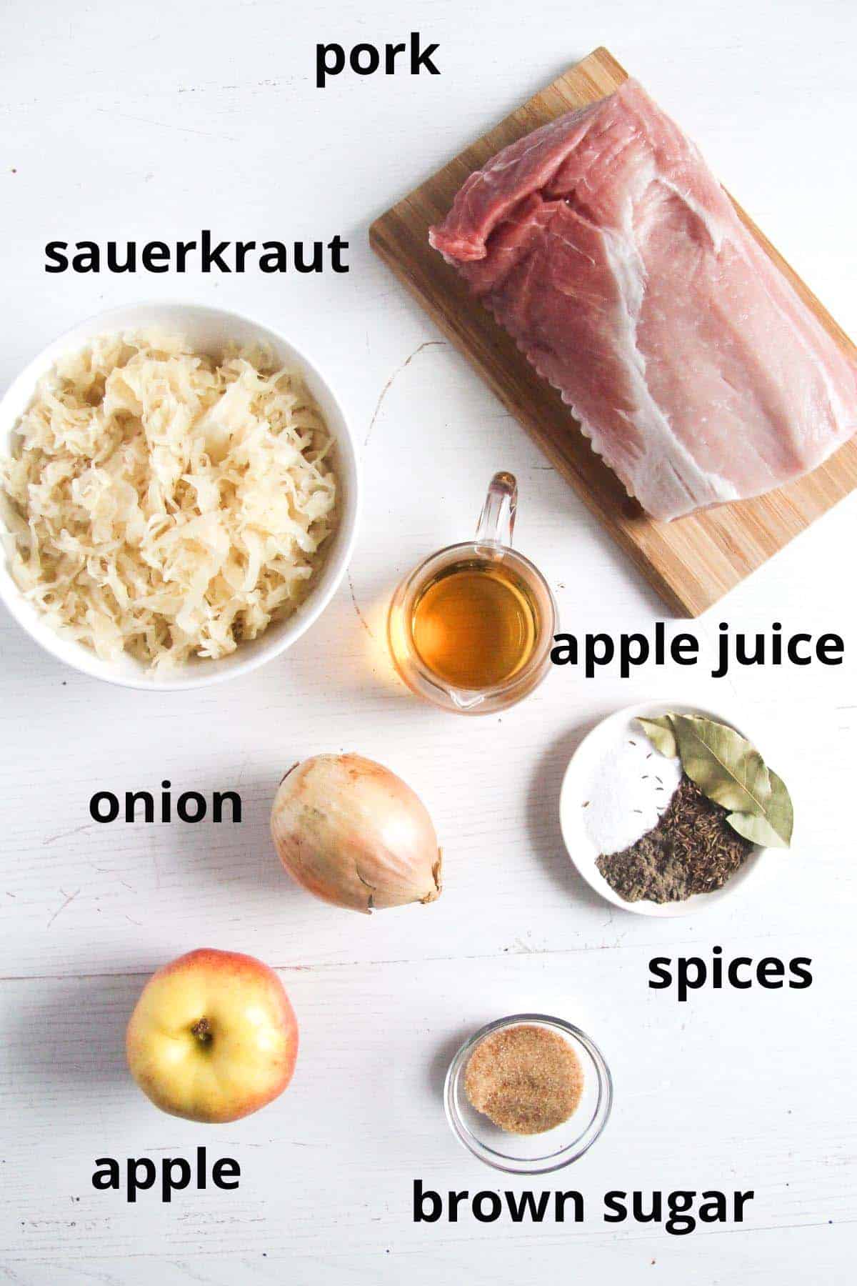 labeled ingredients for pork with sauerkraut on the table.