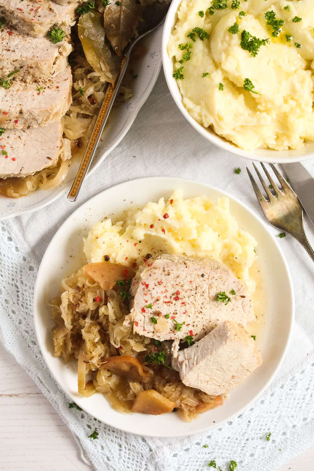 overhead view of plate with meat, kraut and mashed potatoes.