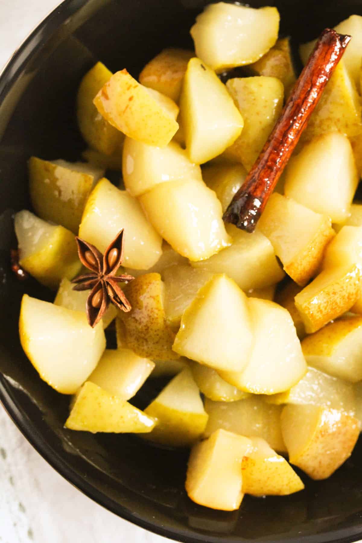 close up chopped stewed pears with cinnamon and anis star.