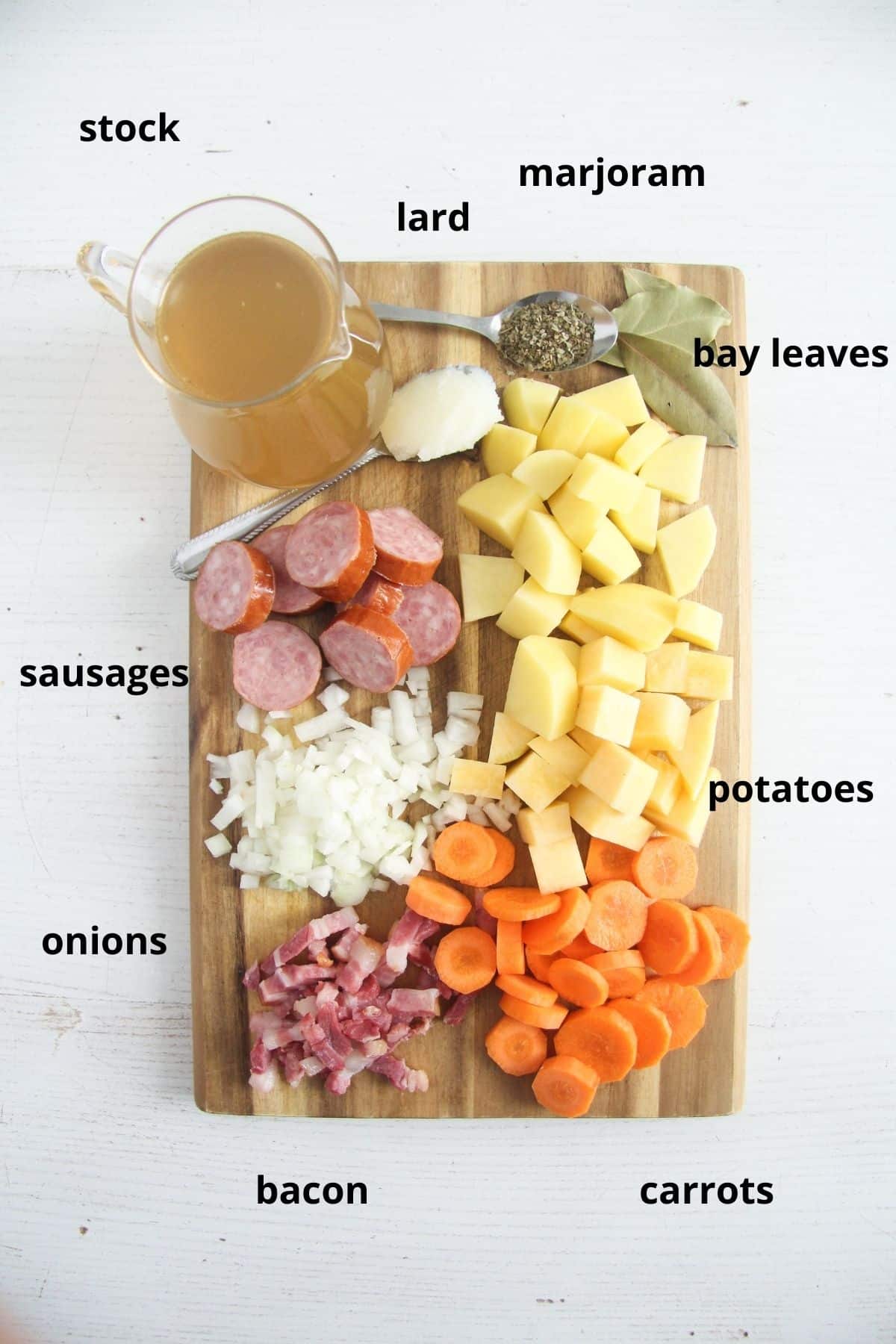 labeled ingredients for rutabaga soup on a wooden board.
