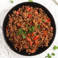 bowl with cooked beef from frozen with pepper pieces in it.