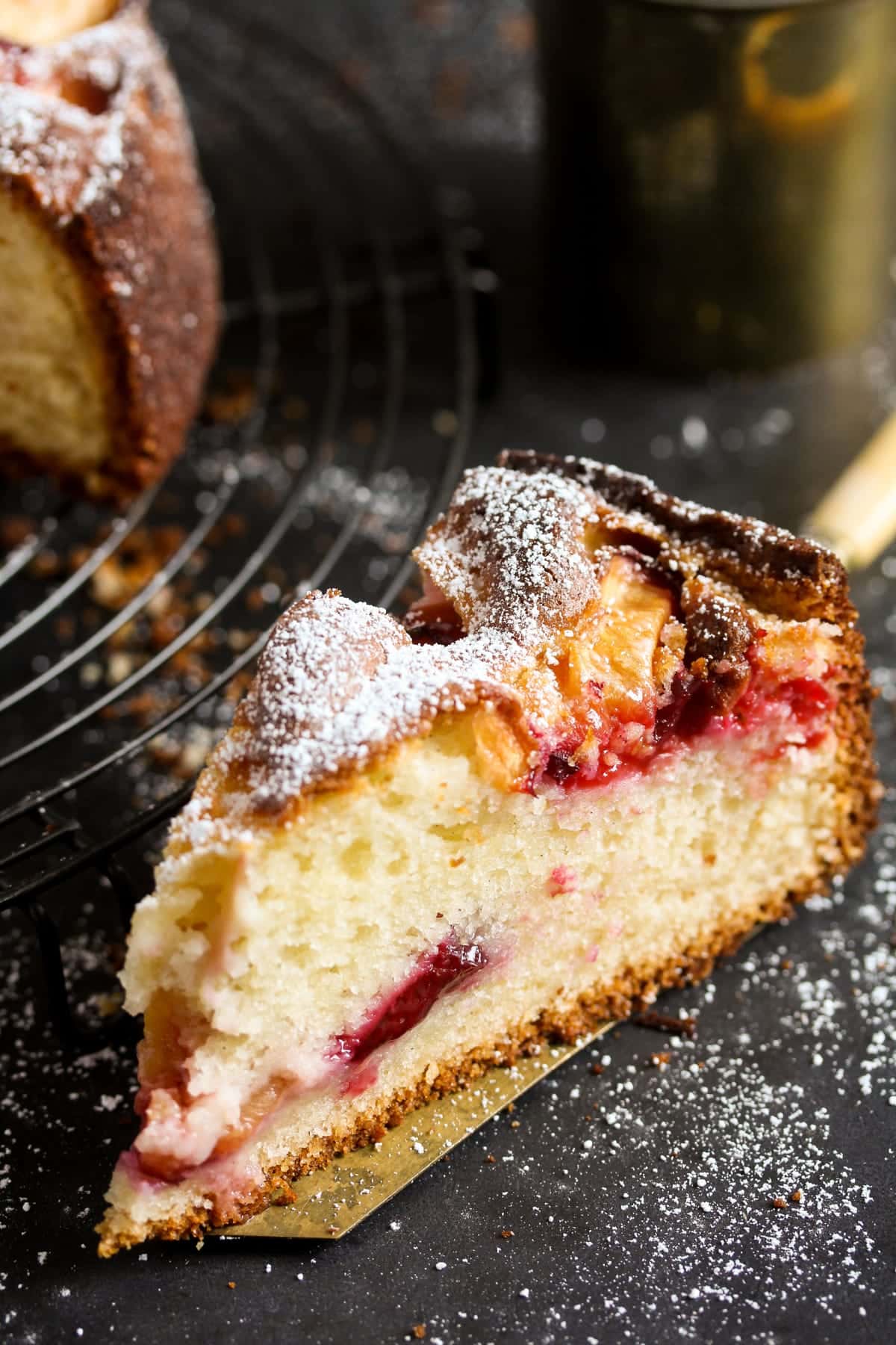a slice of cake with pieces of plum showing.