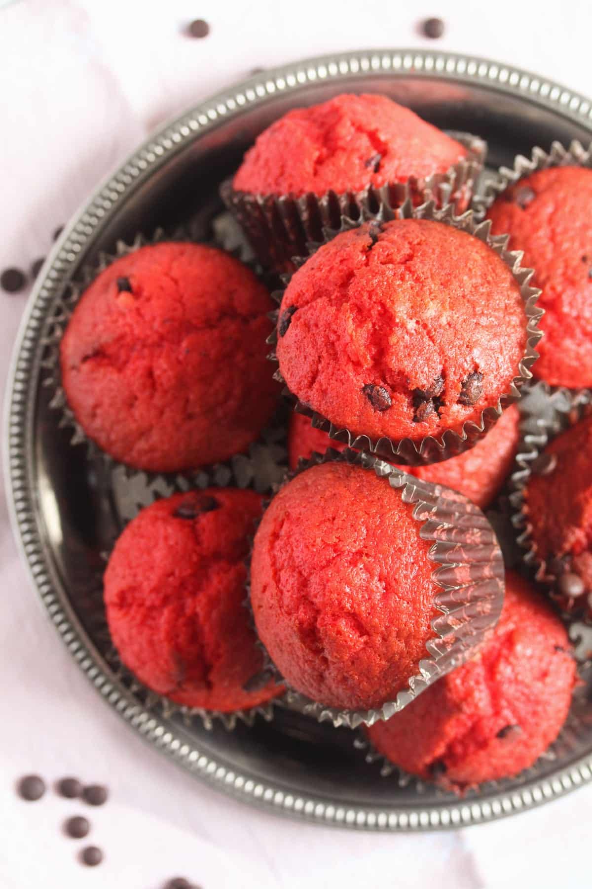many red velvet muffins on a silver tray overhead view.