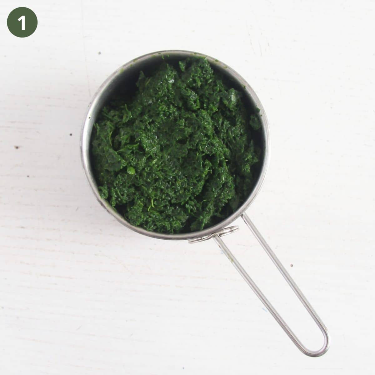 spinach puree in a measuring cup.
