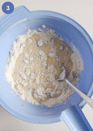 stirring buttermilk into flour mixture with a spoon.