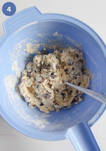 mixing the dough for sweet irish soda bread with a spoon in a bowl.