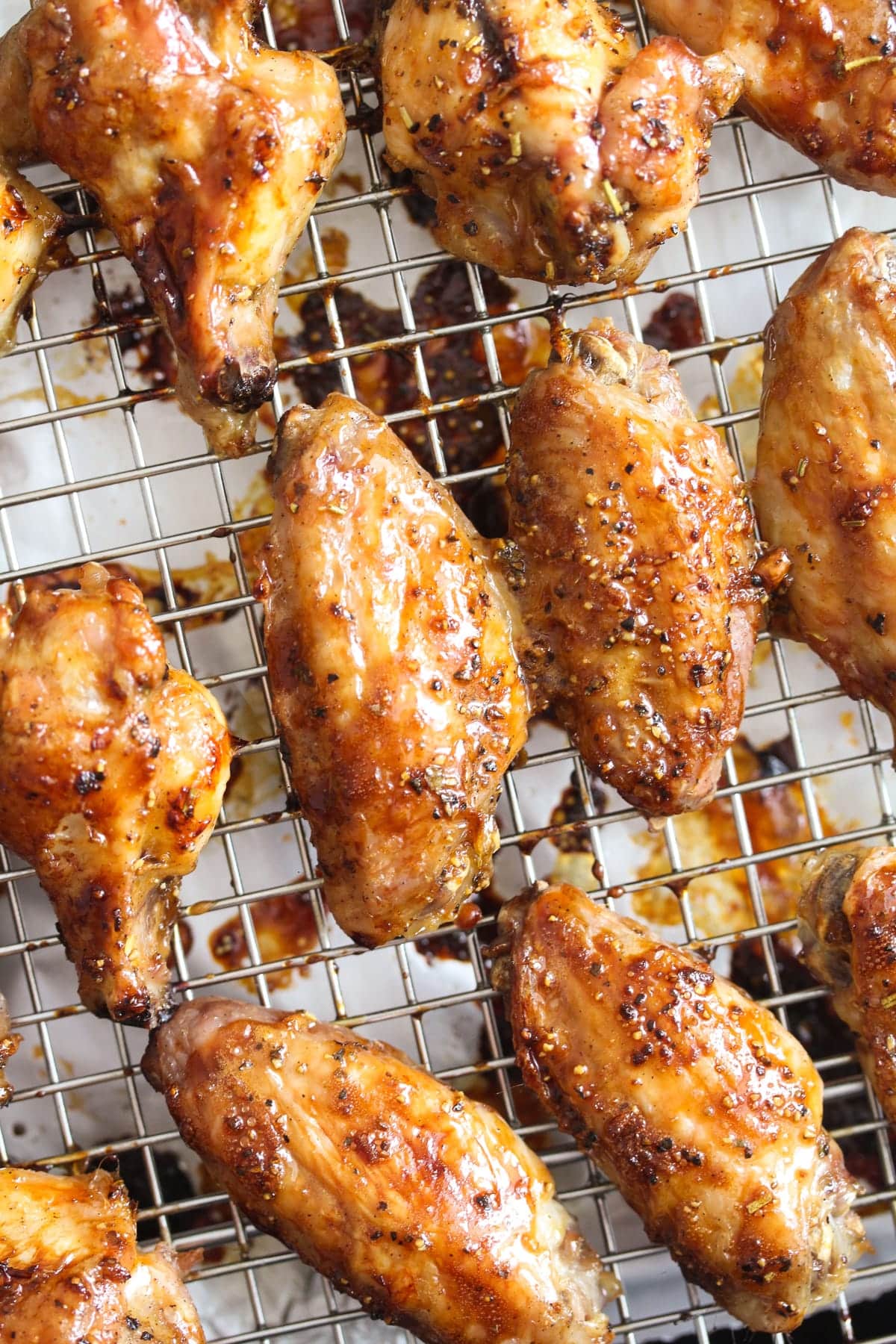 many golden brown baked wings cooked from frozen on a rack.