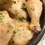 pinterest image of cooked chicken legs in a bowl.